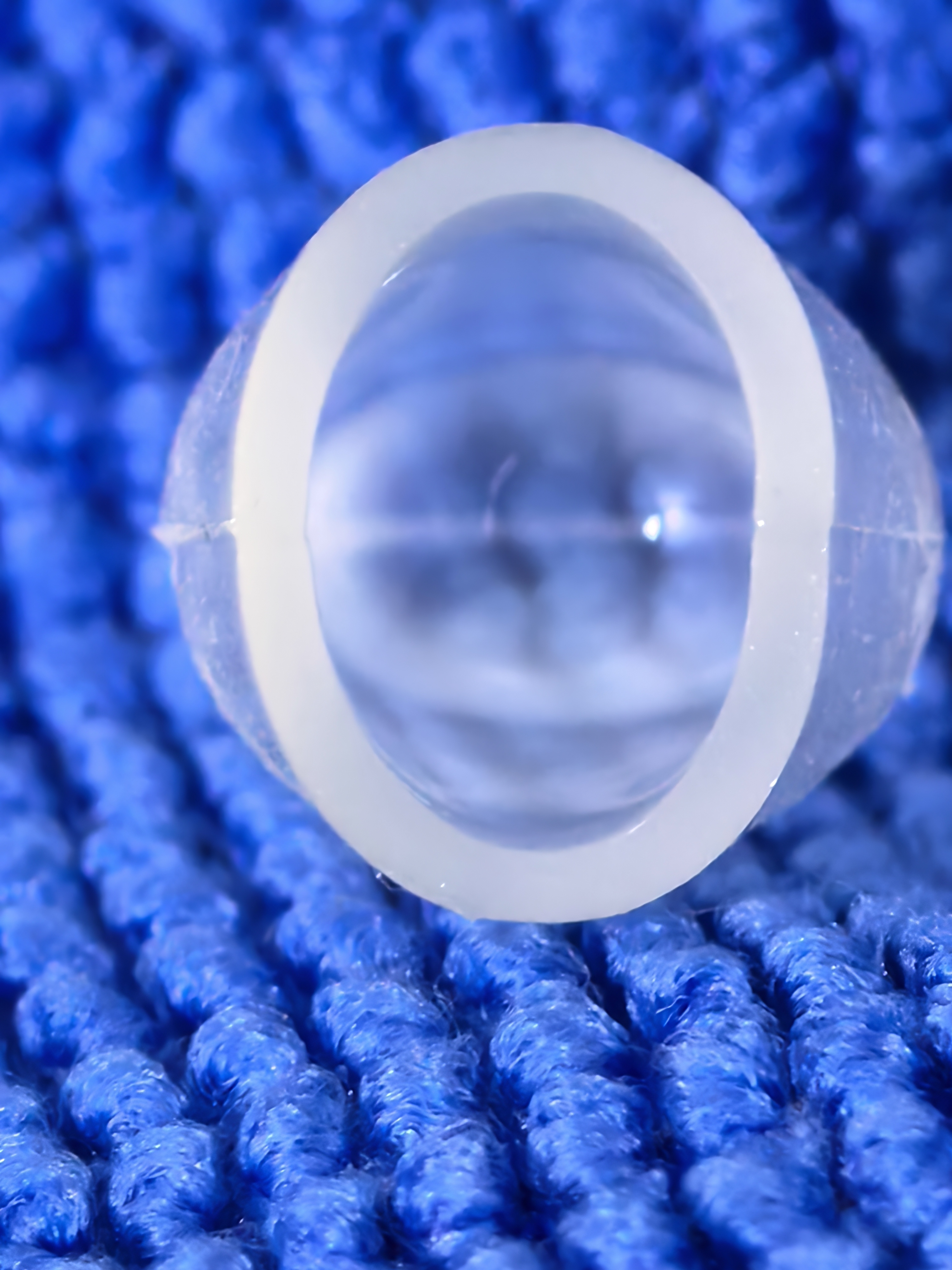 AMYLOM™ PHPS softgel photographed top-down — the translucent starch shell reads completely through, surface gloss and wall uniformity visible at the seam